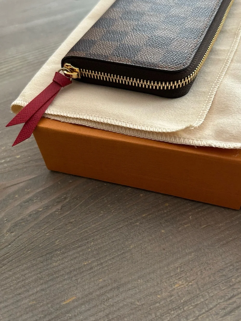 Authentic Louis Vuitton Damier Ebene Zip-Around Wallet with Red Leather Pull